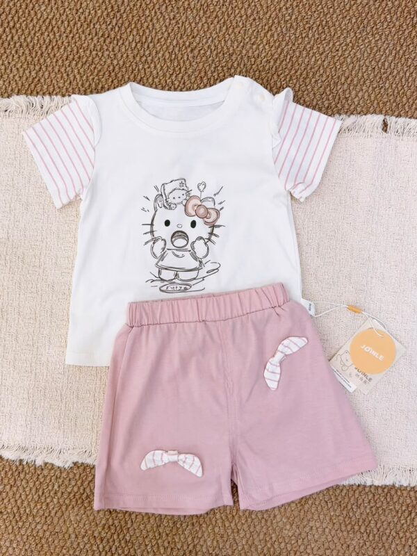 White cartoon-cat short-sleeve top with pink striped sleeves, paired with pink shorts featuring striped bow details.