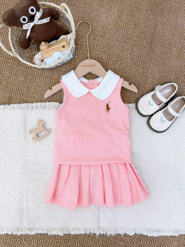 Light pink sleeveless top layered over a matching pleated skirt, with a white Peter Pan collar and brown horse-and-rider motif.