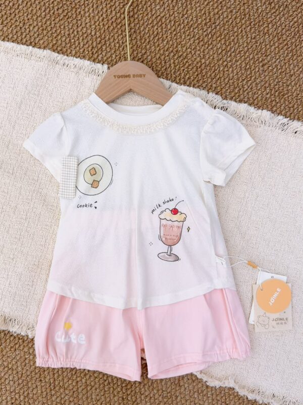White lace-trimmed round-neck top with cookie and pink milkshake prints, paired with pink shorts featuring a star and lettering.