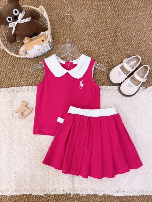 Fuchsia sleeveless top with a white Peter Pan collar and white horse-and-rider motif, beside a fuchsia pleated skirt with a white waistband.