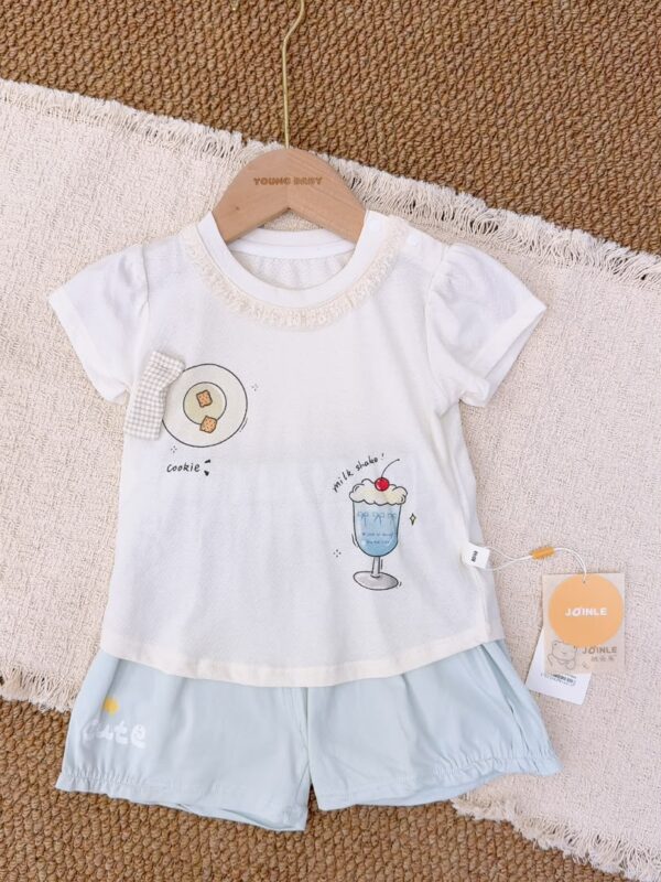 White lace-trimmed round-neck top with cookie and blue milkshake prints, paired with pale blue shorts featuring a star and lettering.