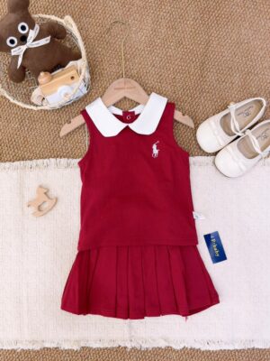 Deep red sleeveless top layered over a matching pleated skirt, with a white Peter Pan collar and white horse-and-rider motif.