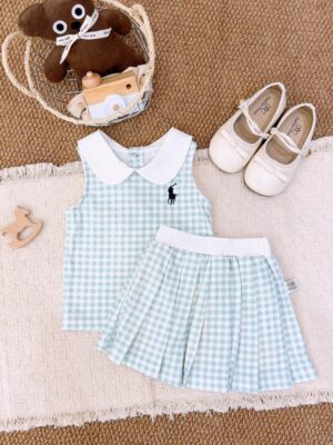 Pale blue-green and white gingham sleeveless top and pleated skirt, with a white Peter Pan collar, white waistband and a dark horse-and-rider chest motif.