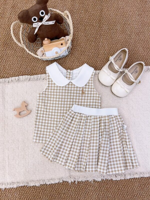 Khaki and white gingham sleeveless top and pleated skirt laid flat, with a white Peter Pan collar, white waistband and a brown-gold horse-and-rider chest motif.