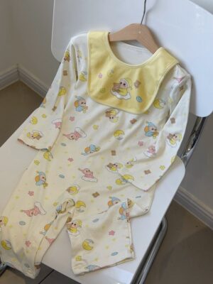 Light cream long-sleeved romper with a yellow bib, featuring cartoon characters in nightcaps, moons, stars and clouds.